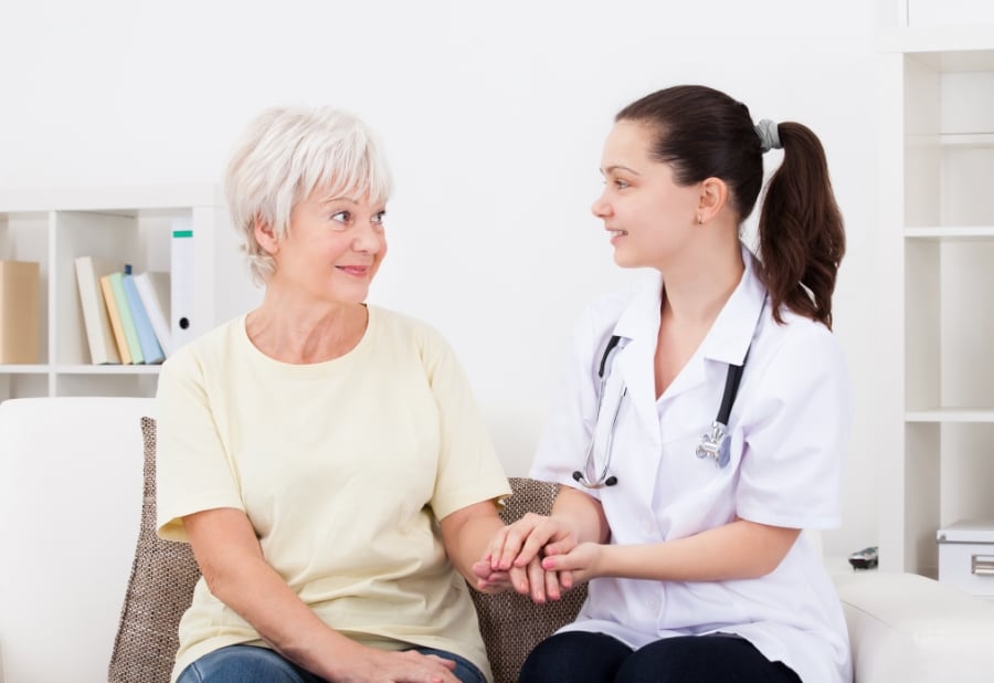 Doctor speaking with an older patient in an exam room
