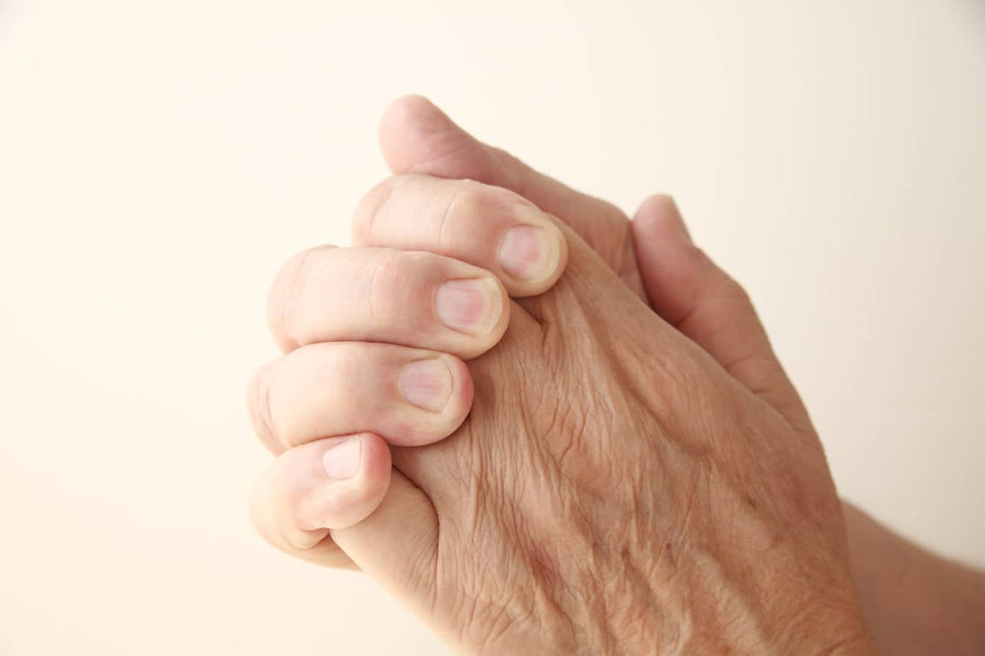 Close-up of hands pressing knuckles together to crack them