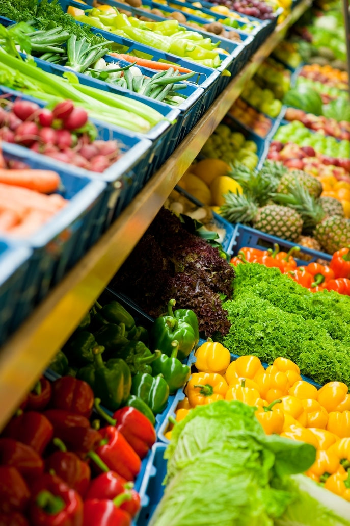 Assortment of fresh whole foods arranged on a wooden surface