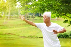 Older adults practicing slow tai chi movements outdoors