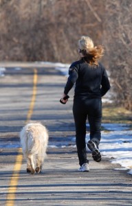 Runner in motion on a road with legs mid-stride