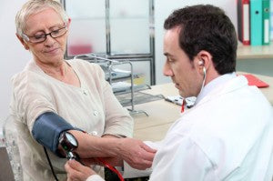 Older woman having her blood pressure taken with a cuff