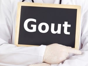 Doctor pointing to the word gout written on a blackboard
