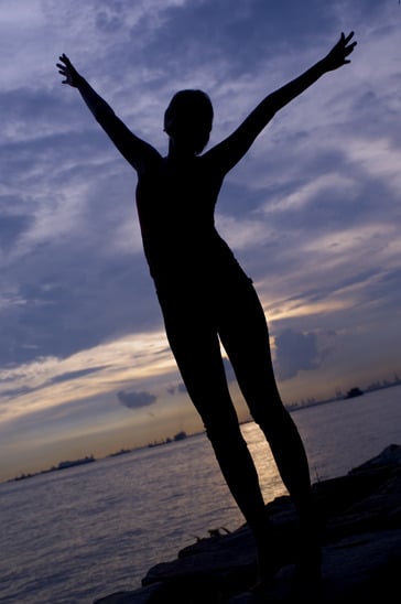 Person stretching their arms overhead after waking up