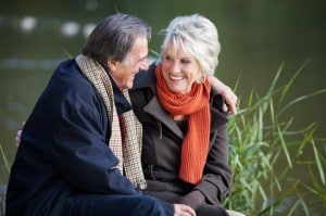Senior couple smiling and embracing outdoors
