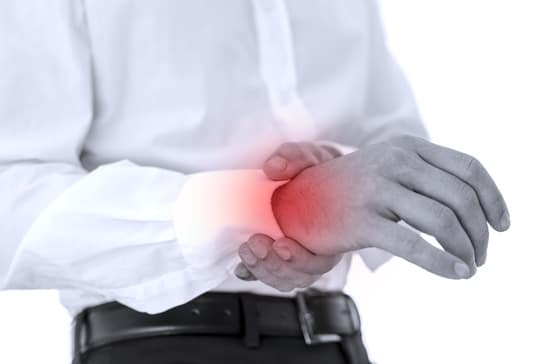 Person gripping their wrist with the opposite hand